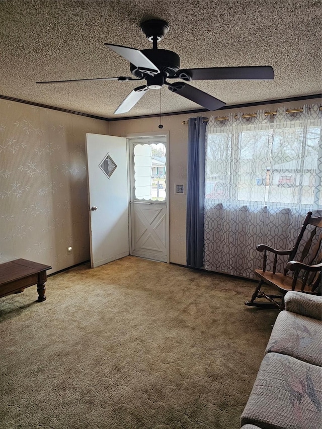 carpeted foyer entrance with a textured ceiling and a ceiling fan