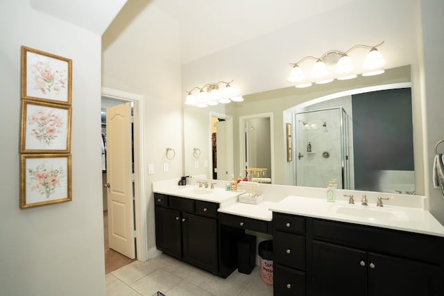 full bathroom with double vanity, tile patterned floors, a sink, and a shower stall