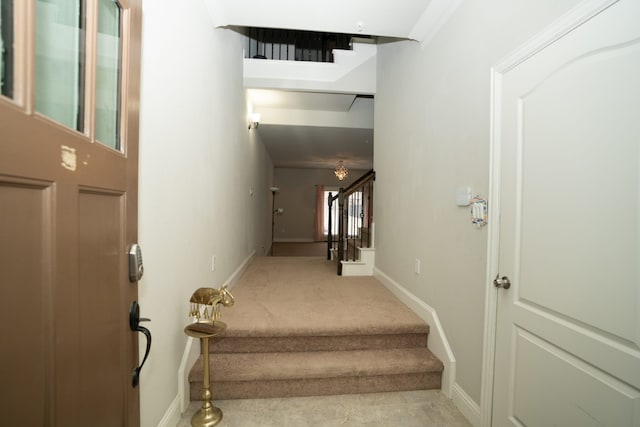 stairway featuring carpet and baseboards