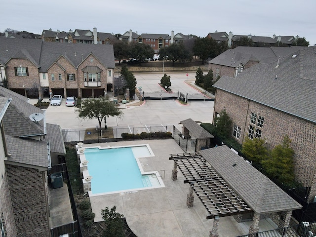 pool with a residential view, central AC, and fence