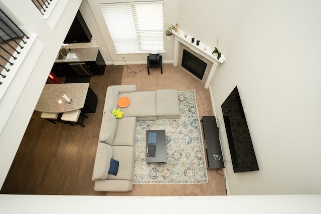 living room with a fireplace, stairway, and baseboards