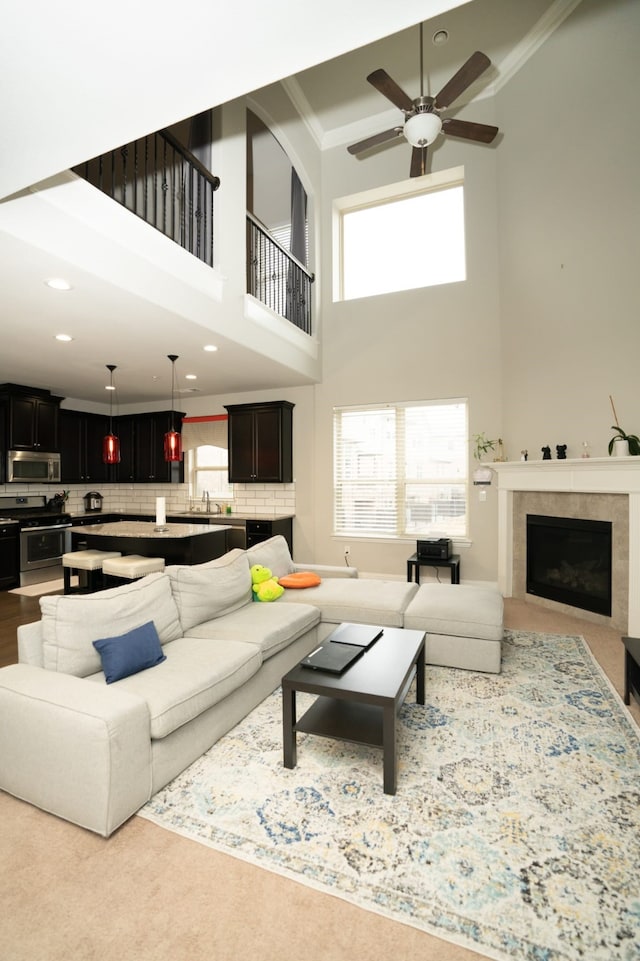 living room featuring recessed lighting, a fireplace, crown molding, and ceiling fan