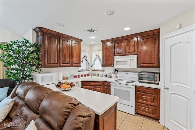 kitchen with visible vents, a toaster, light tile patterned floors, white appliances, and a sink