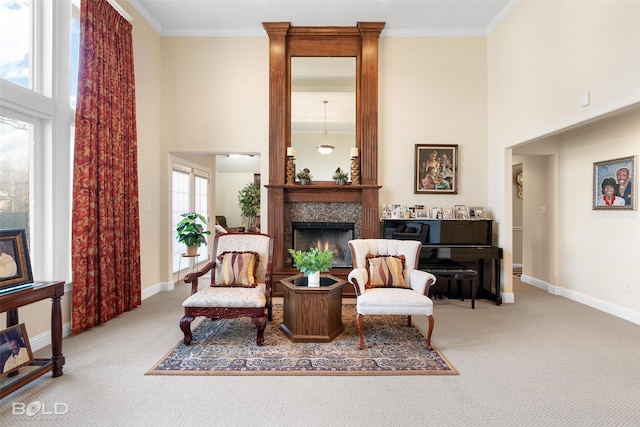 living area with carpet flooring, crown molding, and a towering ceiling