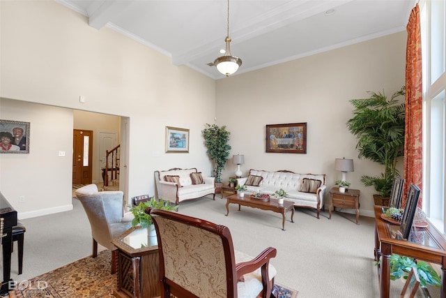 carpeted living room featuring beamed ceiling, baseboards, and ornamental molding