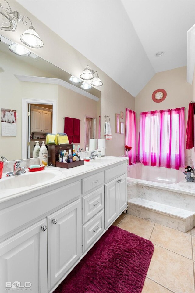 bathroom with vaulted ceiling, double vanity, a bath, tile patterned floors, and a sink