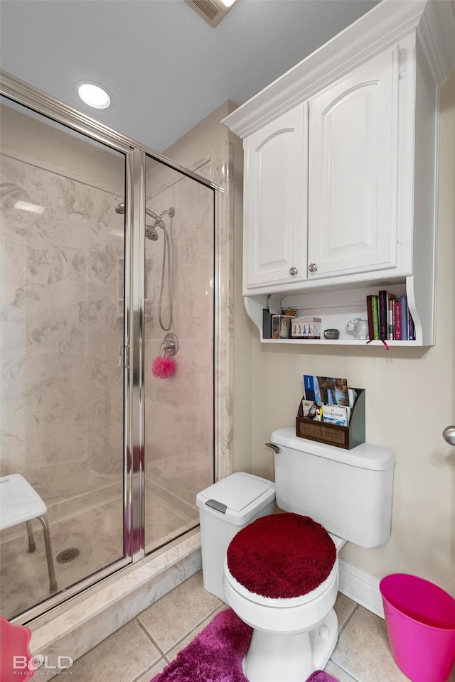 full bathroom with tile patterned flooring, a shower stall, and toilet