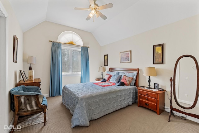 bedroom with vaulted ceiling, light colored carpet, baseboards, and ceiling fan