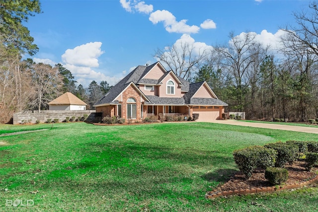 view of front of house featuring a garage, driveway, brick siding, and a front yard