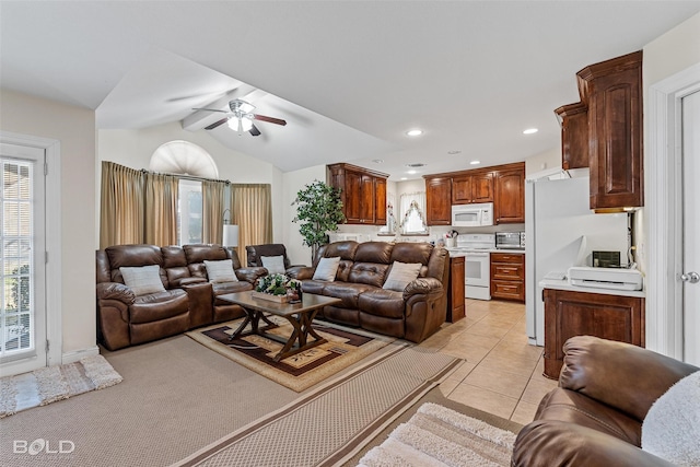 living room featuring a ceiling fan, lofted ceiling, light tile patterned flooring, and recessed lighting