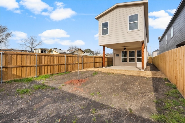 back of property featuring a ceiling fan, a patio area, and a fenced backyard