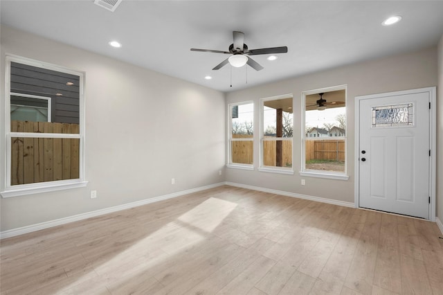 unfurnished room with baseboards, light wood finished floors, and recessed lighting