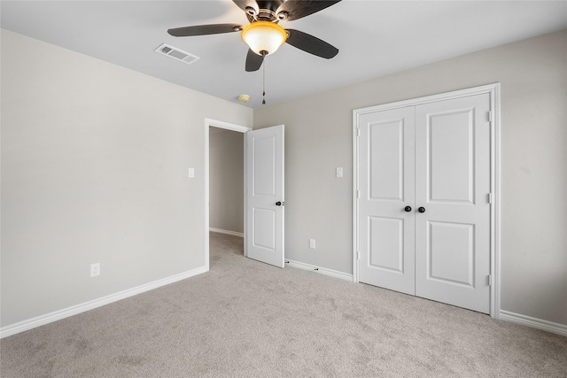 unfurnished bedroom featuring baseboards, visible vents, ceiling fan, carpet floors, and a closet