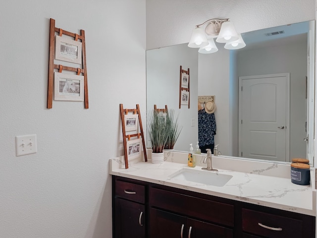 bathroom with visible vents and vanity