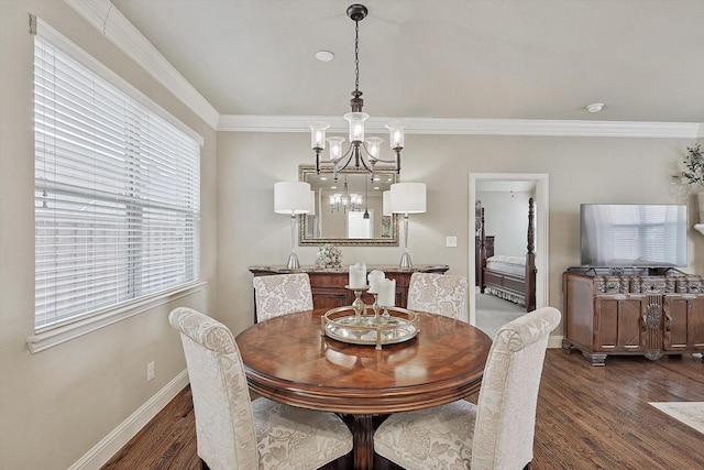 dining space with baseboards, a chandelier, wood finished floors, and crown molding