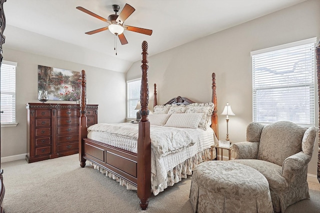 carpeted bedroom with a ceiling fan, lofted ceiling, and baseboards