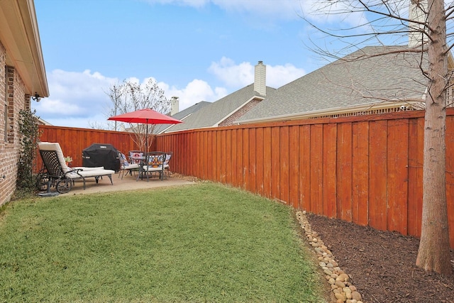 view of yard with a patio area and a fenced backyard