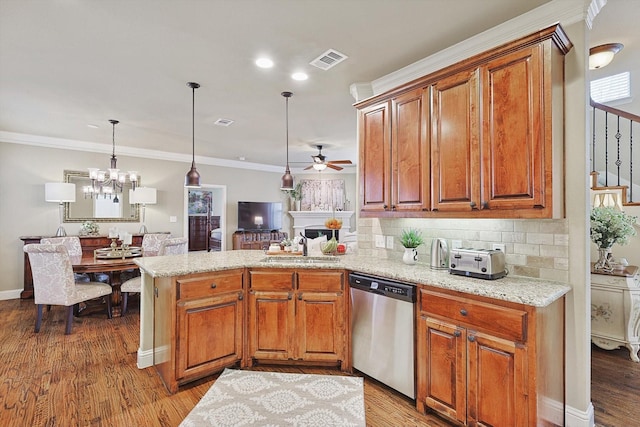 kitchen with visible vents, stainless steel dishwasher, ornamental molding, a sink, and a peninsula