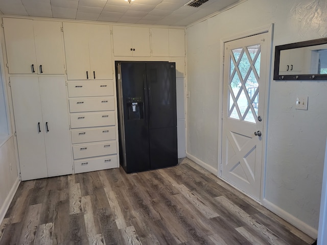 foyer featuring dark wood-type flooring and baseboards