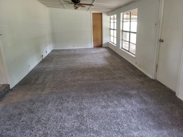 unfurnished room with dark carpet