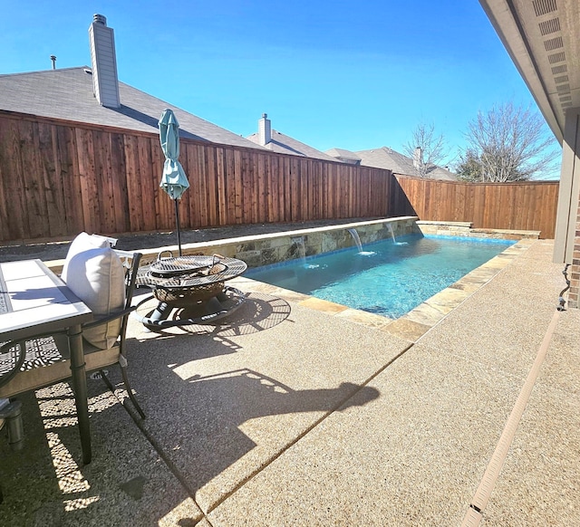 view of swimming pool with a fenced in pool, a patio, and a fenced backyard