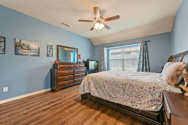 bedroom with baseboards, visible vents, a ceiling fan, dark wood-type flooring, and vaulted ceiling