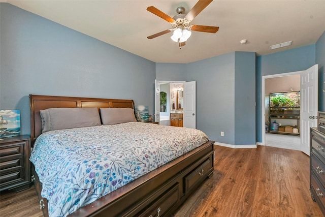 bedroom featuring dark wood-style floors, baseboards, visible vents, and ceiling fan