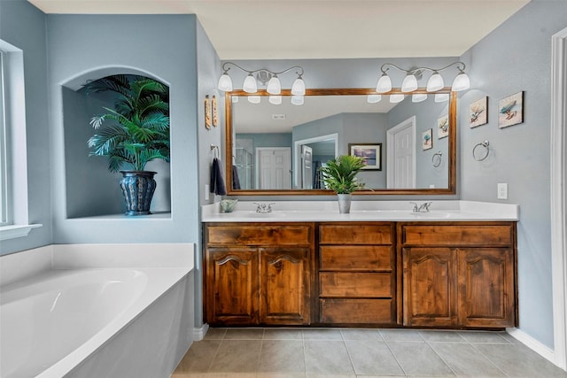 full bathroom featuring double vanity, tile patterned flooring, and a garden tub