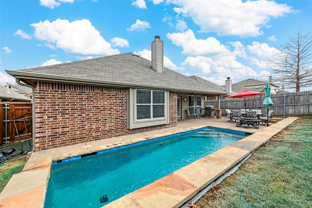 view of pool featuring a fenced in pool, a fenced backyard, and a patio