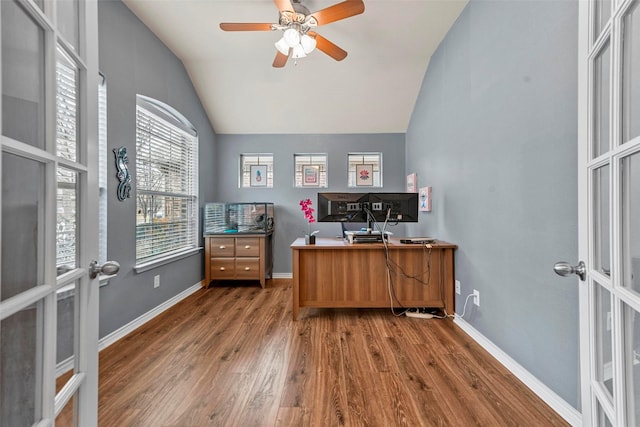 office space with a ceiling fan, baseboards, vaulted ceiling, french doors, and dark wood-style floors