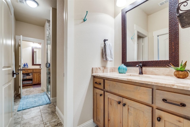 full bath featuring tile patterned flooring, vanity, visible vents, and baseboards