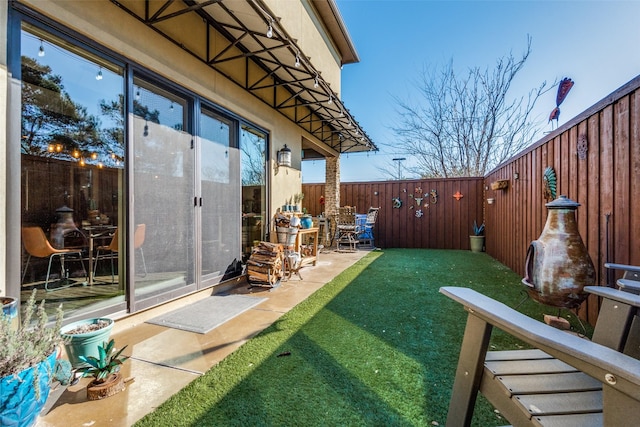 view of yard with a patio area and a fenced backyard