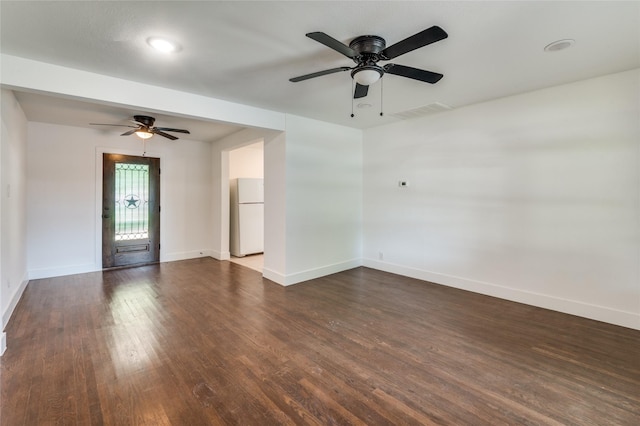 unfurnished room with ceiling fan, visible vents, baseboards, and dark wood-type flooring