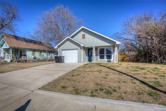 ranch-style house featuring driveway, an attached garage, and a front yard