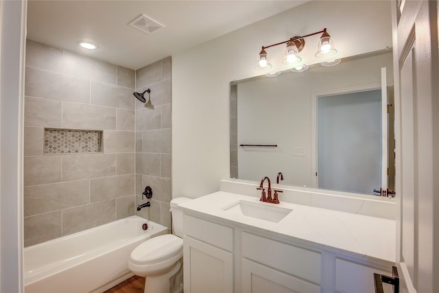 full bathroom featuring toilet, visible vents, tub / shower combination, and vanity