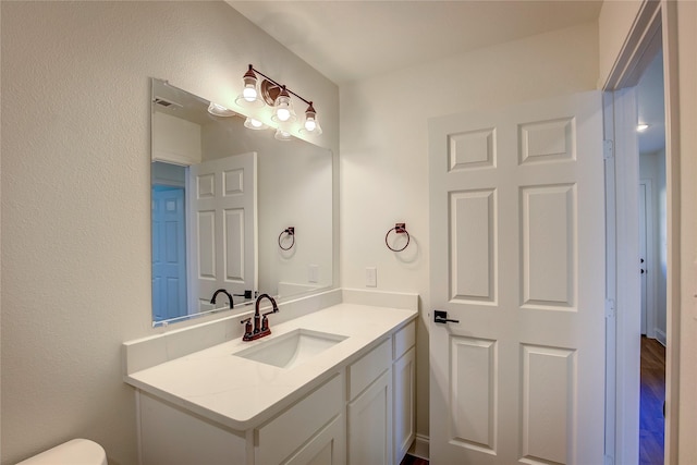 half bathroom featuring visible vents and vanity