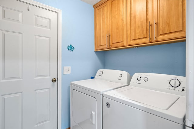 laundry area featuring cabinet space and washer and clothes dryer