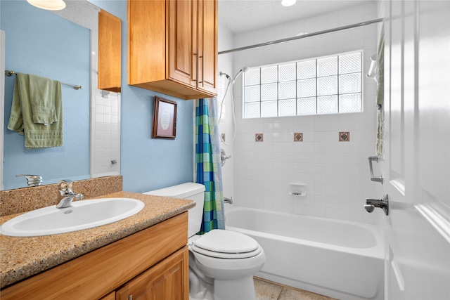 full bath with a textured ceiling, a textured wall, toilet, shower / tub combo, and vanity