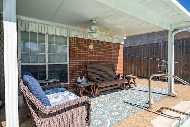 view of patio featuring fence and a ceiling fan