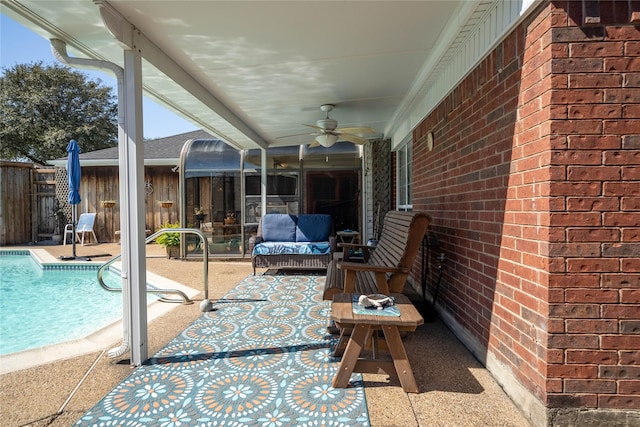 view of patio featuring ceiling fan, fence, and a fenced in pool