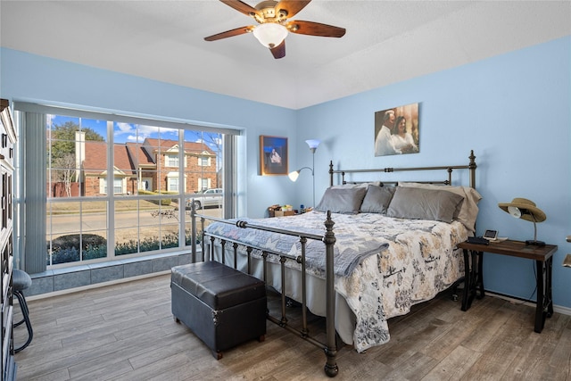 bedroom with baseboards, a ceiling fan, and wood finished floors