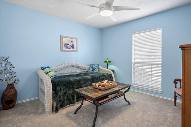 bedroom with a textured ceiling, ceiling fan, carpet, and baseboards