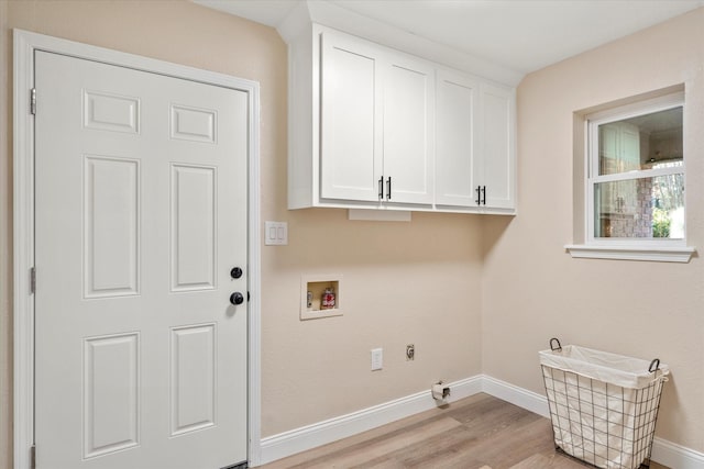 laundry room with washer hookup, baseboards, cabinet space, and light wood finished floors