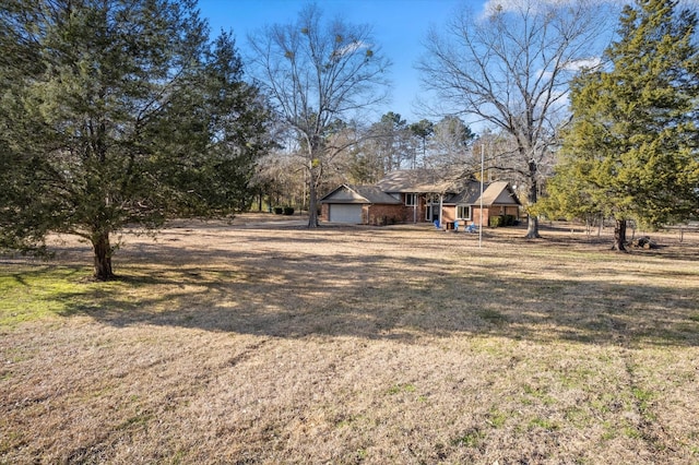 view of yard featuring driveway and an attached garage