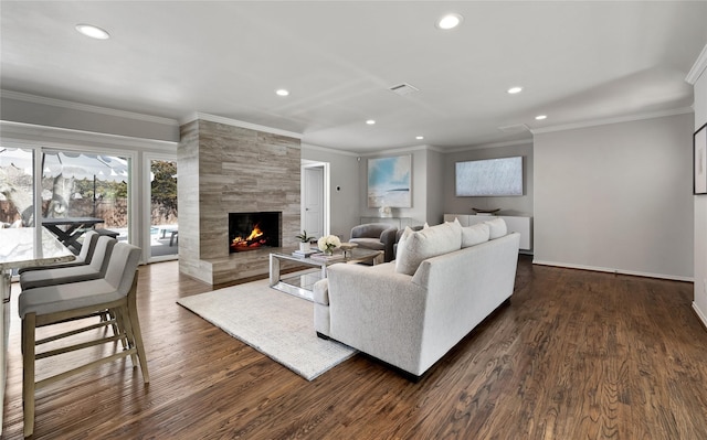 living area with dark wood-type flooring, recessed lighting, visible vents, and a fireplace