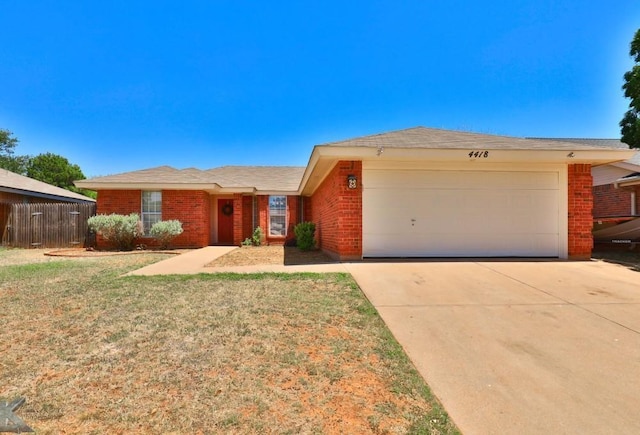 ranch-style house with concrete driveway, an attached garage, fence, a front lawn, and brick siding