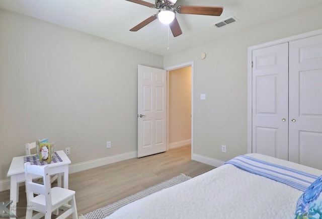 bedroom with visible vents, ceiling fan, baseboards, and wood finished floors