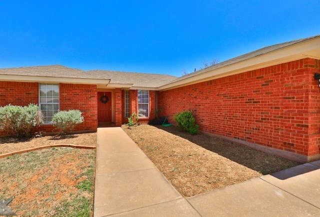 property entrance featuring brick siding