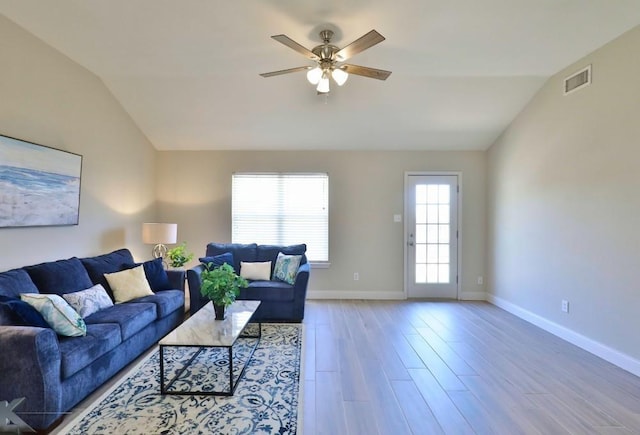 living area with light wood-style flooring, visible vents, ceiling fan, and lofted ceiling