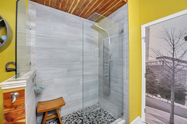 bathroom featuring wood ceiling and tiled shower